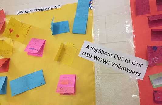 Photograph of elementary school wall that shows thank you notes from students along with a shout out to WOW volunteers.