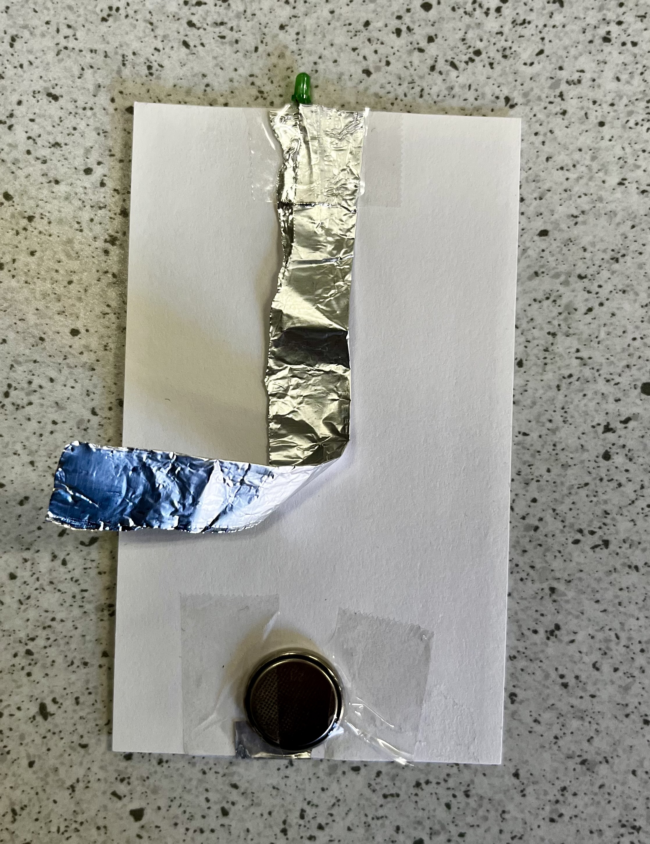 notecard with button battery, foil, and bulb