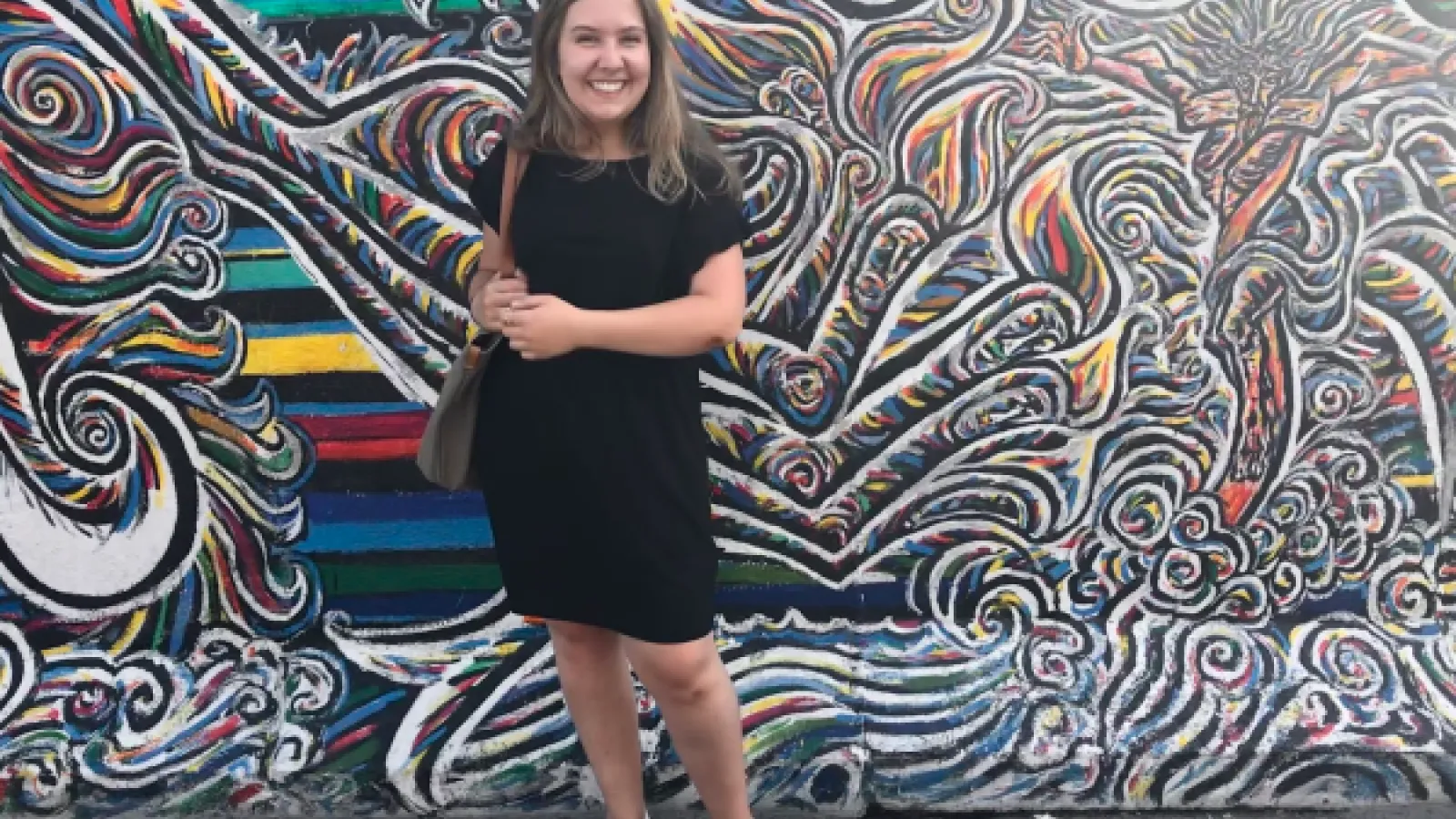 Photo of Allison in Germany in front of wall art. 