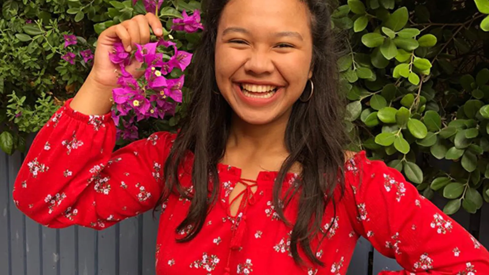Photograph of Hana on her study abroad to Cyprus in front of a flowering tree.
