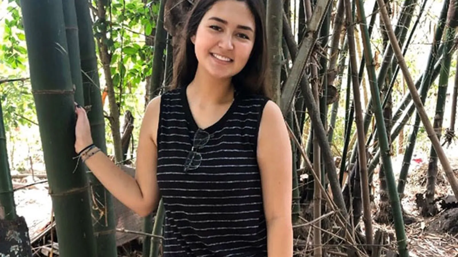 Photo of Rosemary posing in front of bamboo stalks