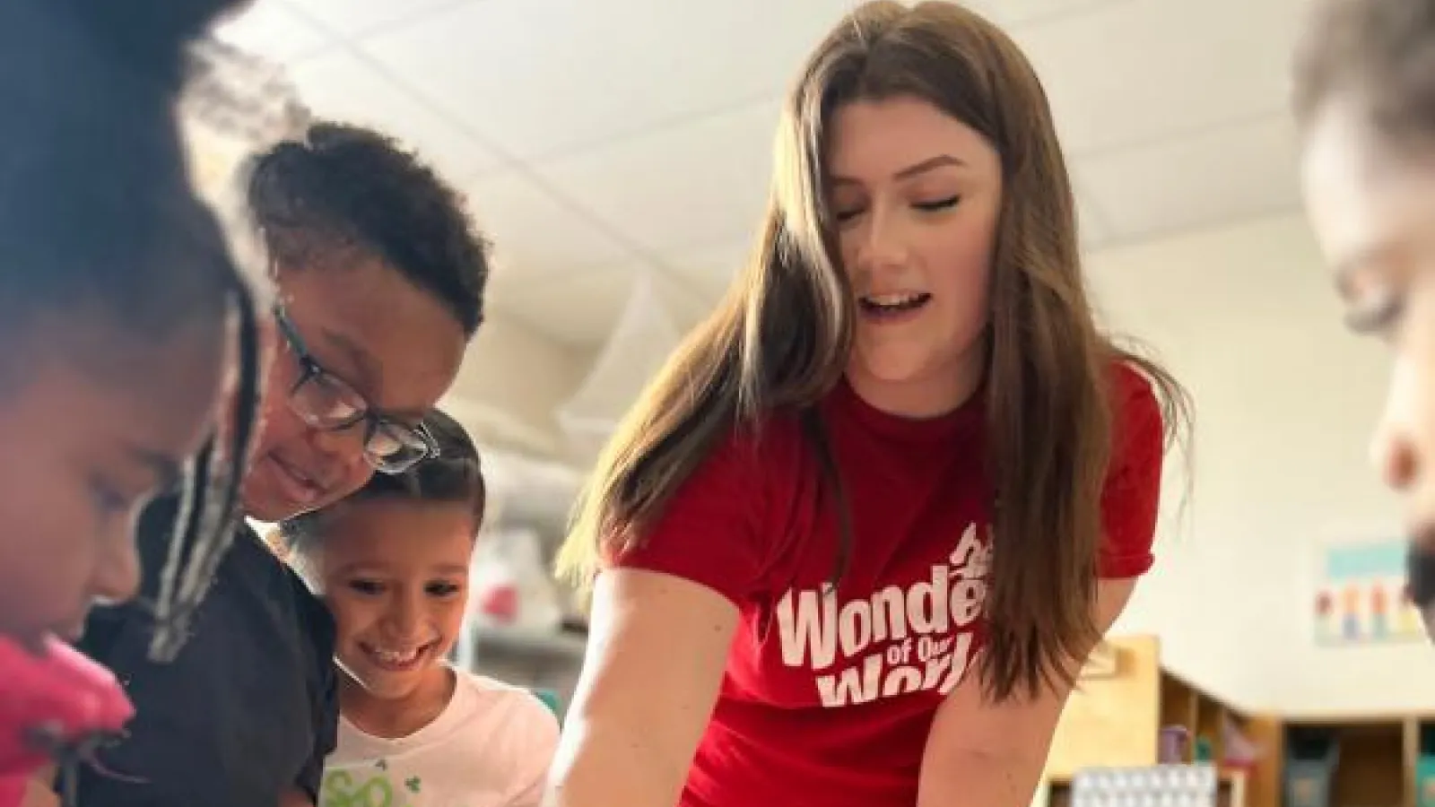 wow volunteer interacts with students