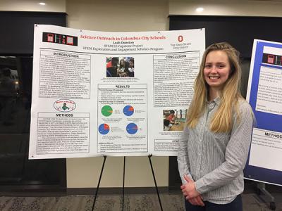 Photograph of Leah Dunston at a poster session presenting about the WOW Program