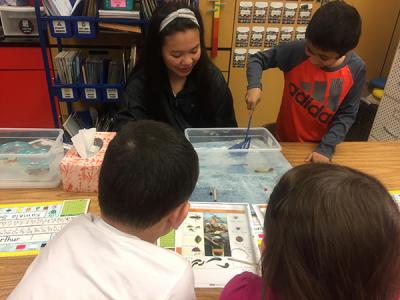 Photograph of Hana teaching 1st graders about water quality