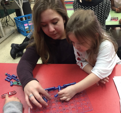 Photograph of Allison teaching about circuits with kindergarten student named Allison. 
