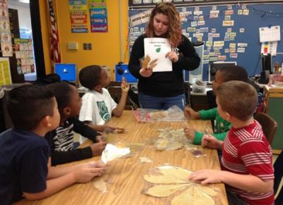 Photograph of Kyla talking to 2nd graders about leaf identification