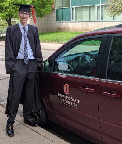 Photograph of Andrew next to the WOW van