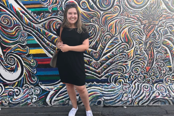 Photo of Allison in Germany in front of wall art. 