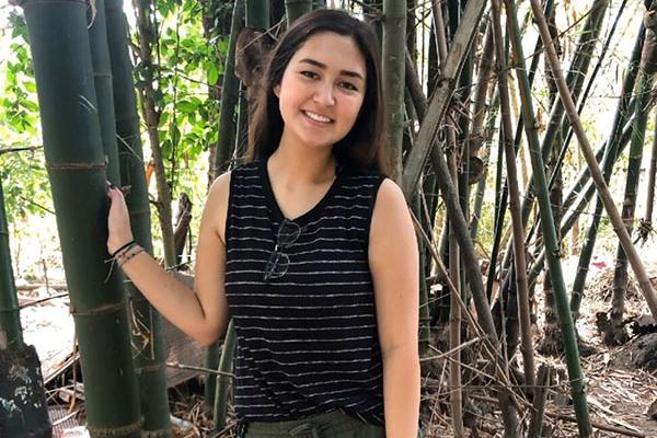 Photo of Rosemary posing in front of bamboo stalks