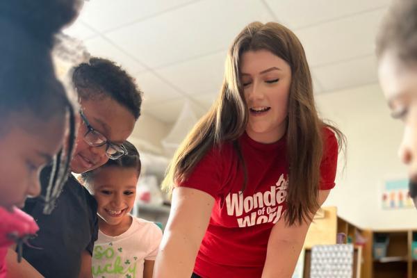 wow volunteer interacts with students