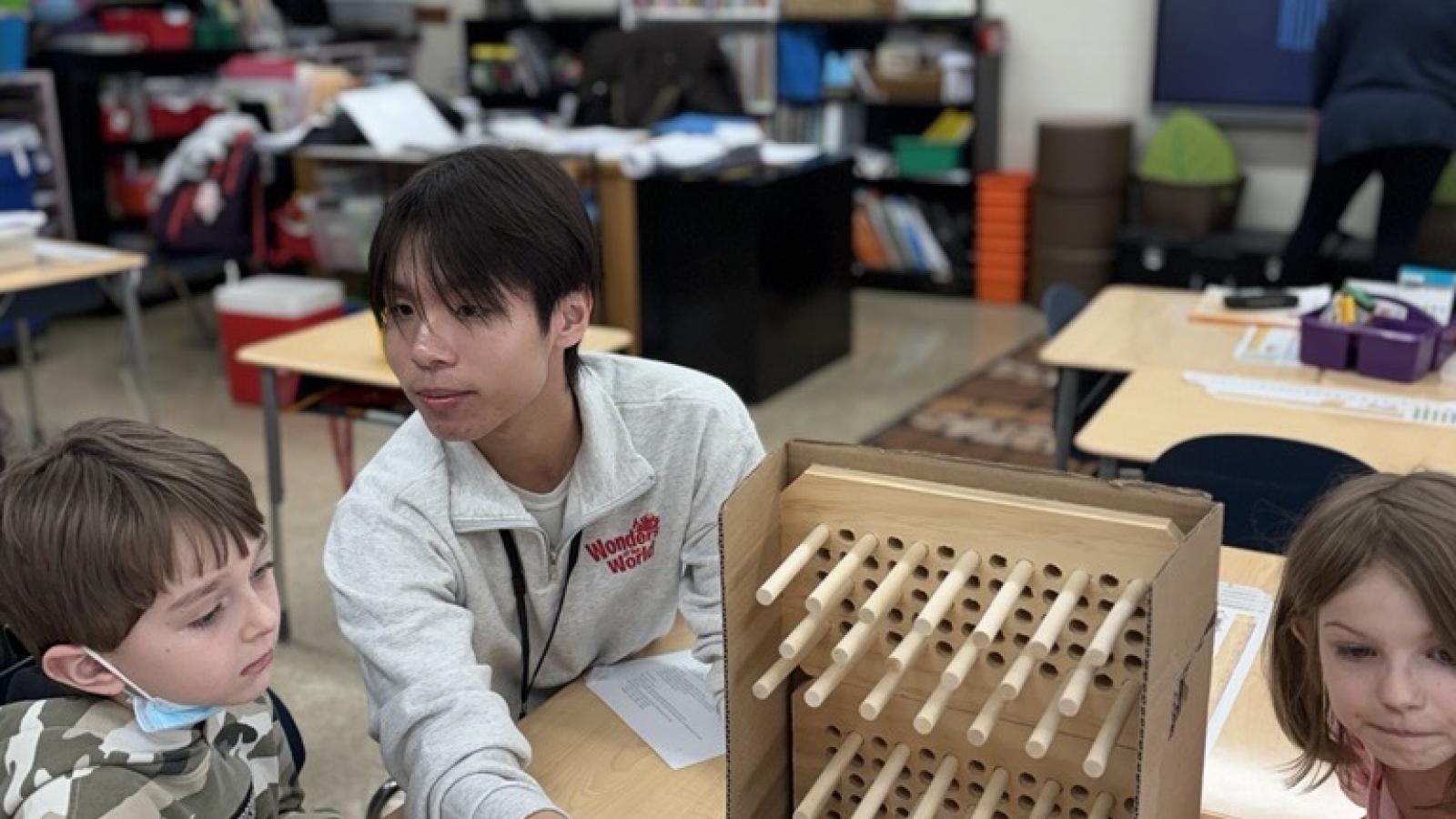 wow volunteer teaches students
